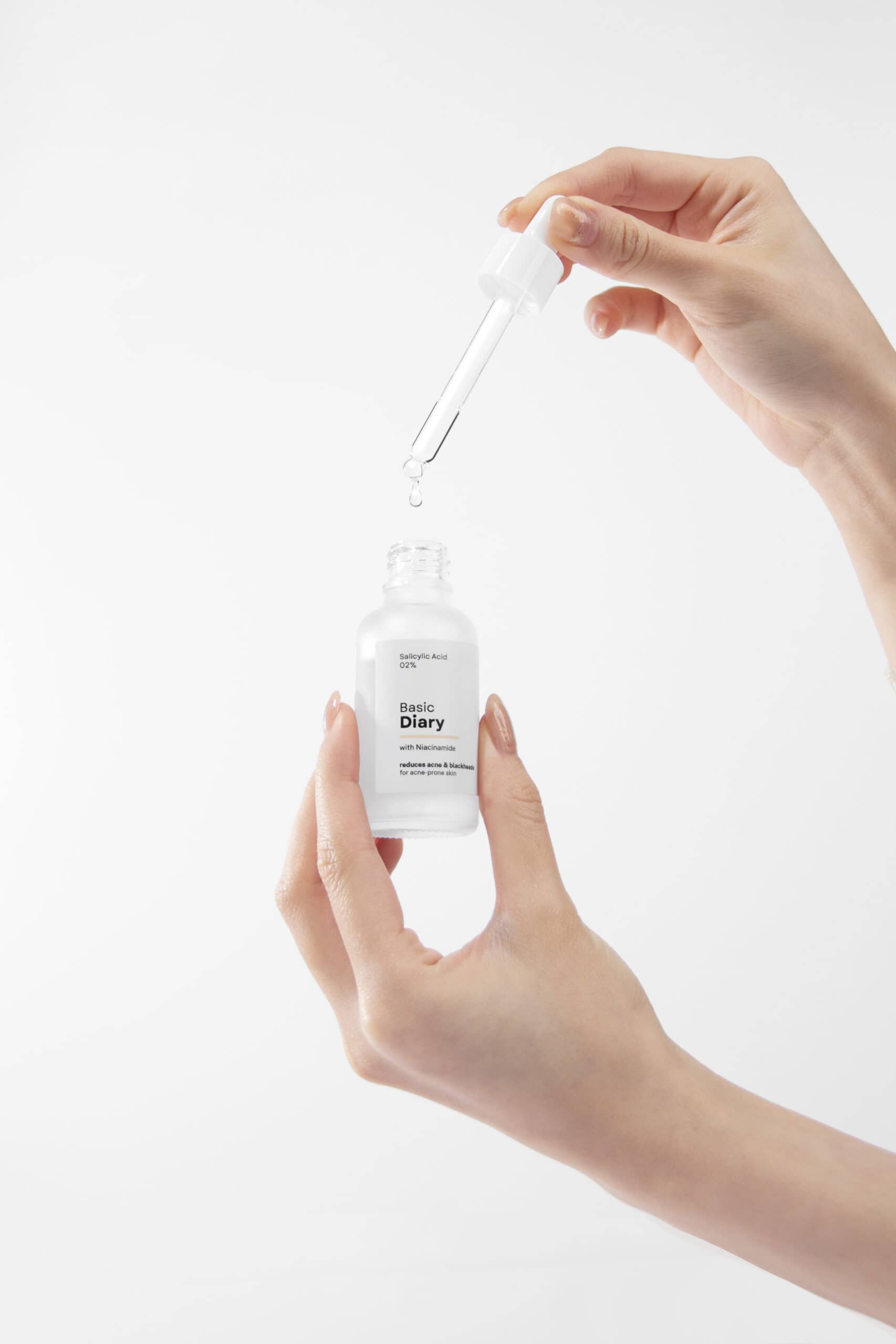 hand and serum droplets product photography
